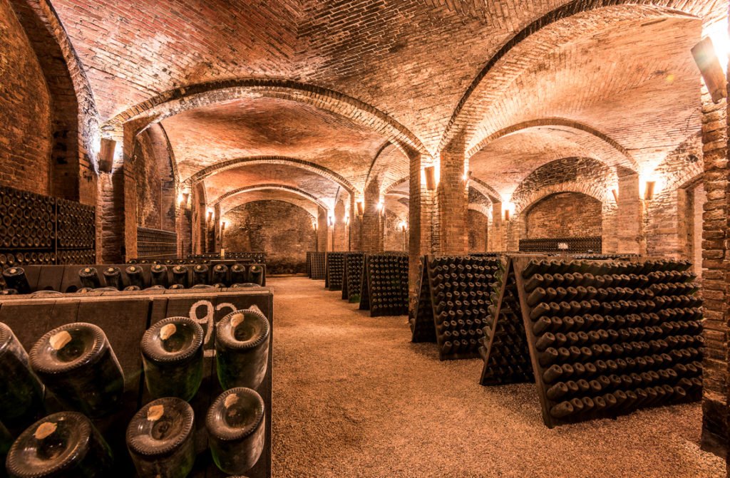 Contratto Cellar in Canelli.The historic cathedral cellars, now designated to become a UNESCO Heritage Site, are a real treasure, and among the finest of their kind. These huge underground cellars, covering more than 5,000 square meters, were built into the heart of the hill that protects the small town of Canelli, excavated from tuff limestone to a depth of 32 meters